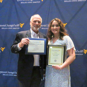 Sophia Lord posing for a photo next to interim president Paul Kreider